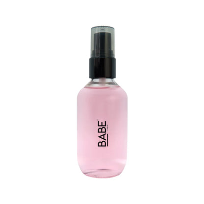 Pink bottle of Oil Control Setting Spray with black cap, designed to reduce shine and oil, featuring witch hazel and magnolia extracts.