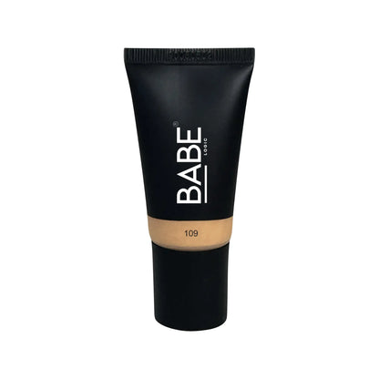Black tube of tinted moisturizer with brand logo, offering sheer coverage and hydration for all skin types.
