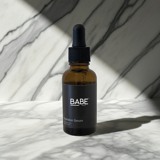 Hydration serum bottle with dropper on marble surface, moisturizing skincare product with glycerin and cassia seed extract