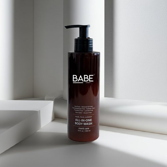 Bottle of Babe brand all-in-one body wash with pump dispenser for hair, face, and body care, sulfate-free and made with natural ingredients.