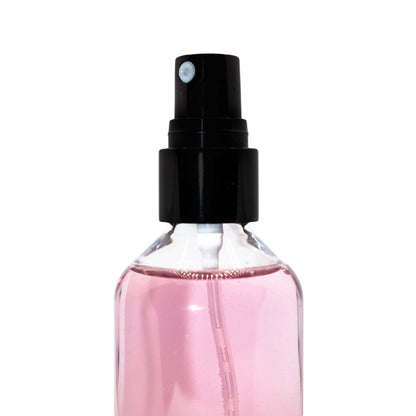 Pink bottle of oil control setting spray with black nozzle.