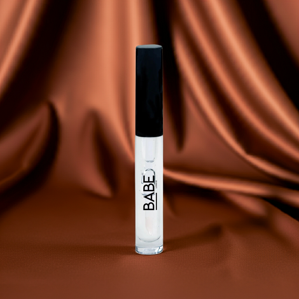 Clear plumping lip gloss tube with black cap on brown satin background